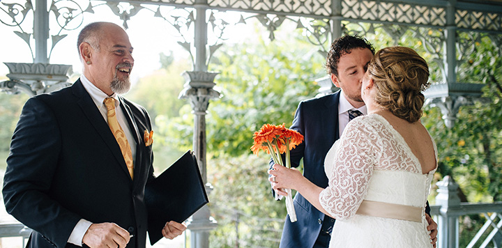 NYC Wedding Officiant Peter Boruchowitz watches Bride and Groom's first kiss at their Central Park Wedding